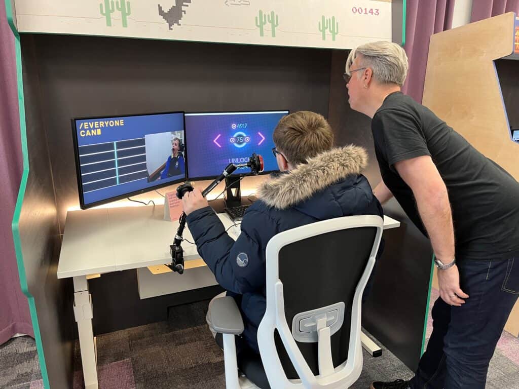 A young man plays a video game where you use your head to control the action.