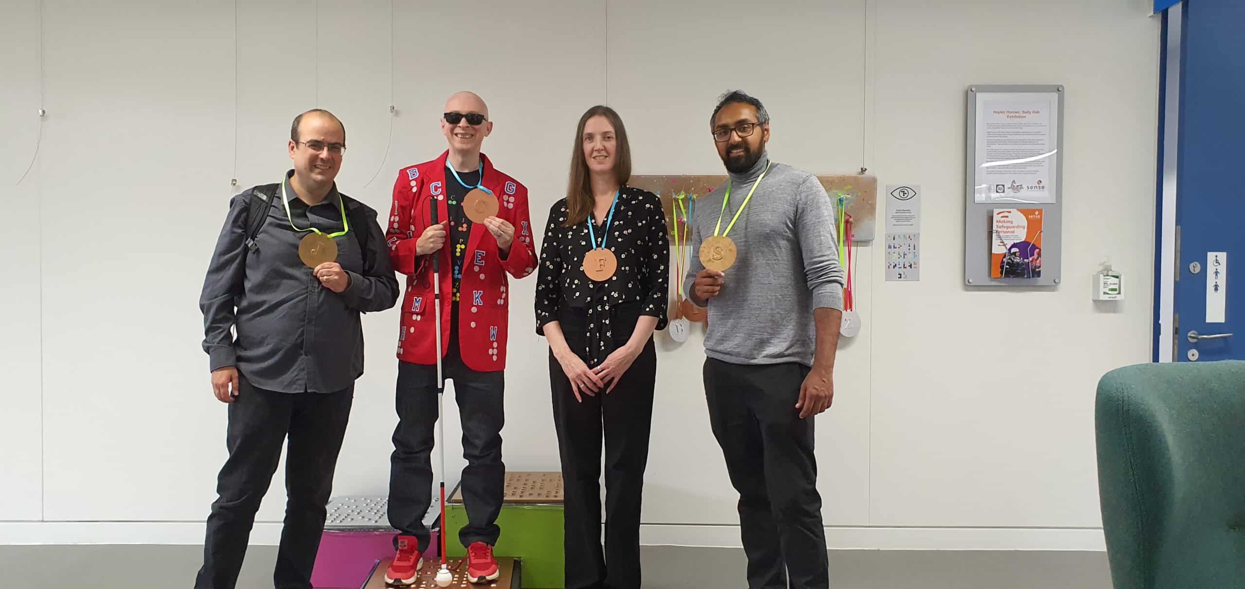 A group of people stood in a room wearing medals