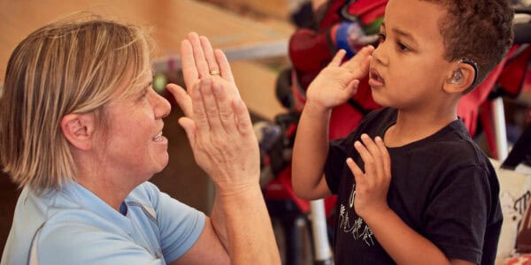 Child high-fives an older woman