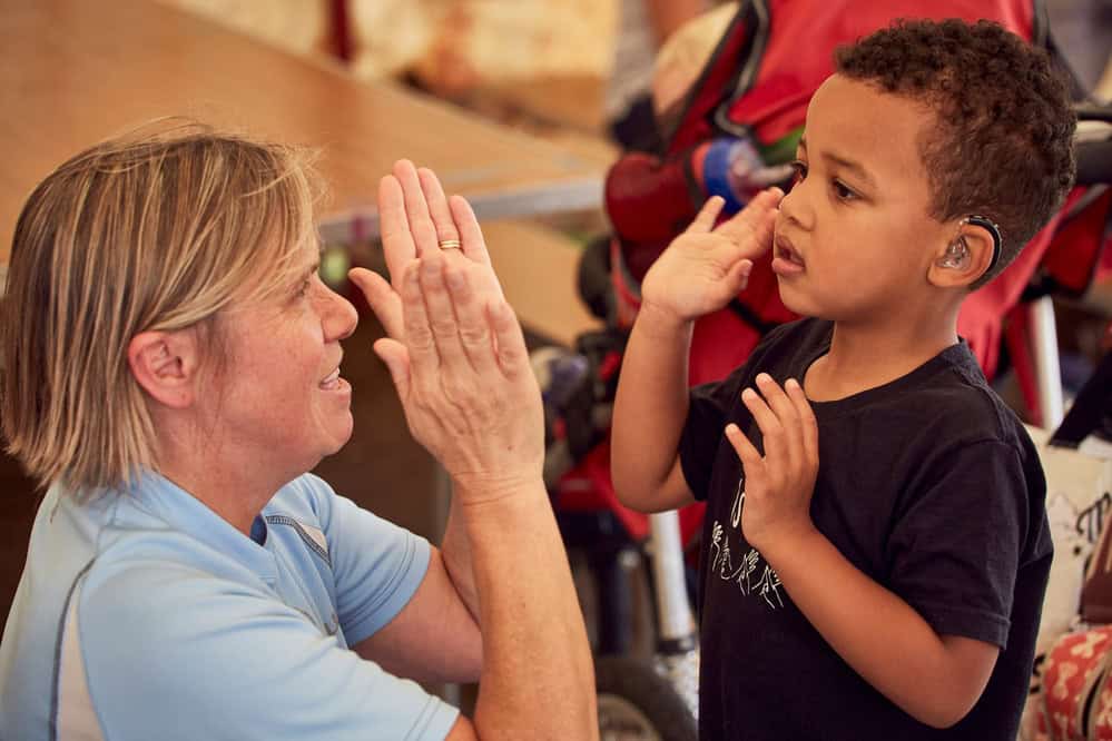 Child high-fives an older woman