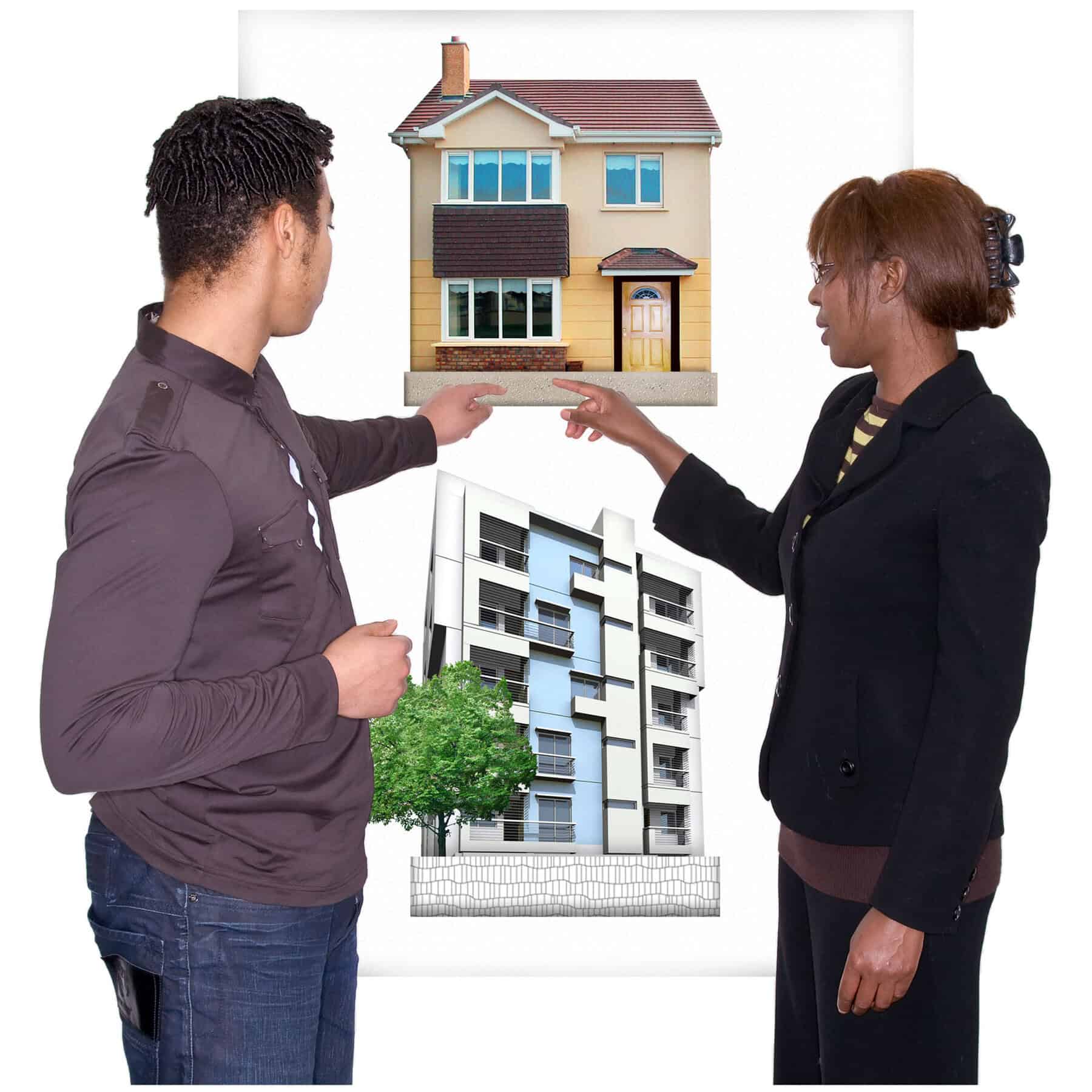 2 people point at a house