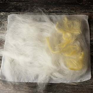 Image shows the white wool tops with a bit of yellow added on the right