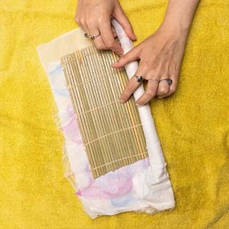 A bamboo mat is layed over the mesh