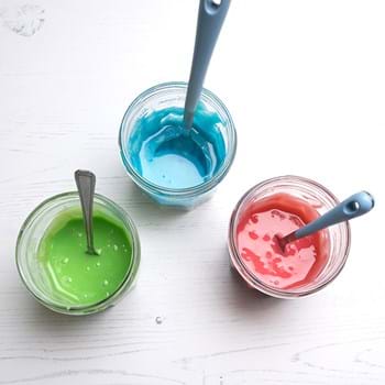 Three pots of paint in green, blue and red