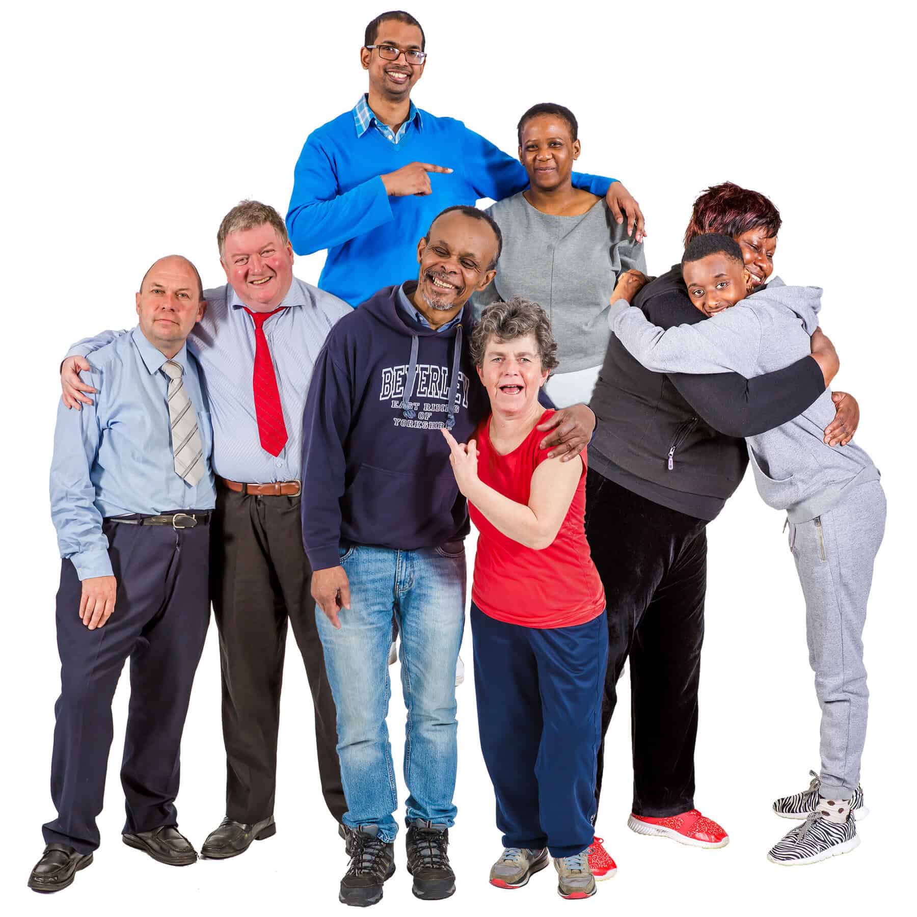 A group of people smile and hug