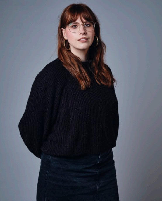 A headshot of a woman wearing all black