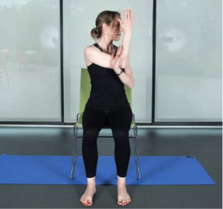 woman with her right arm bent across her body