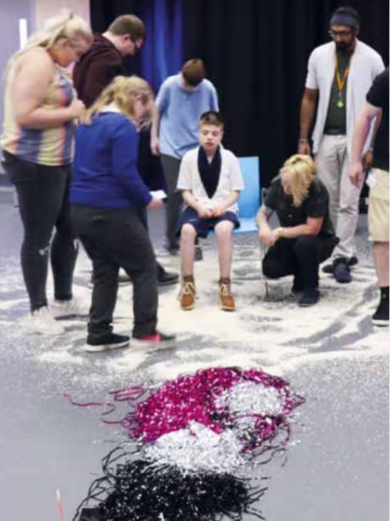Dancing on rice, with a young boy participating