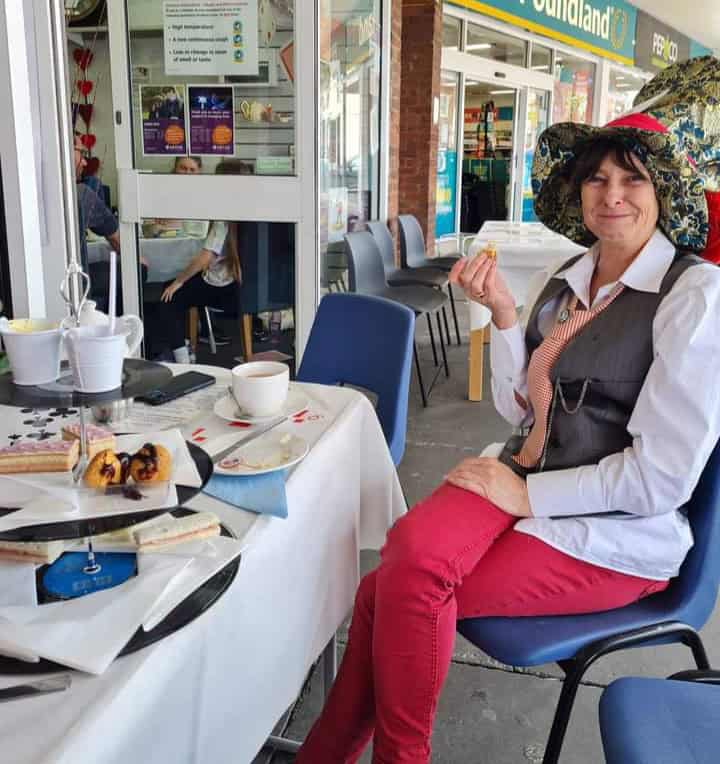 Julia from Billerciay sitting at a table at her Sensational Tea Party.
