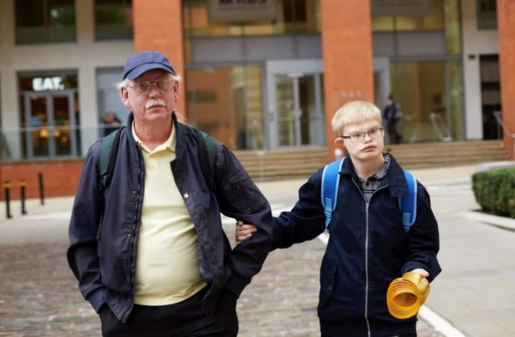 Keith and his son Geordie walking along arm-in-arm.