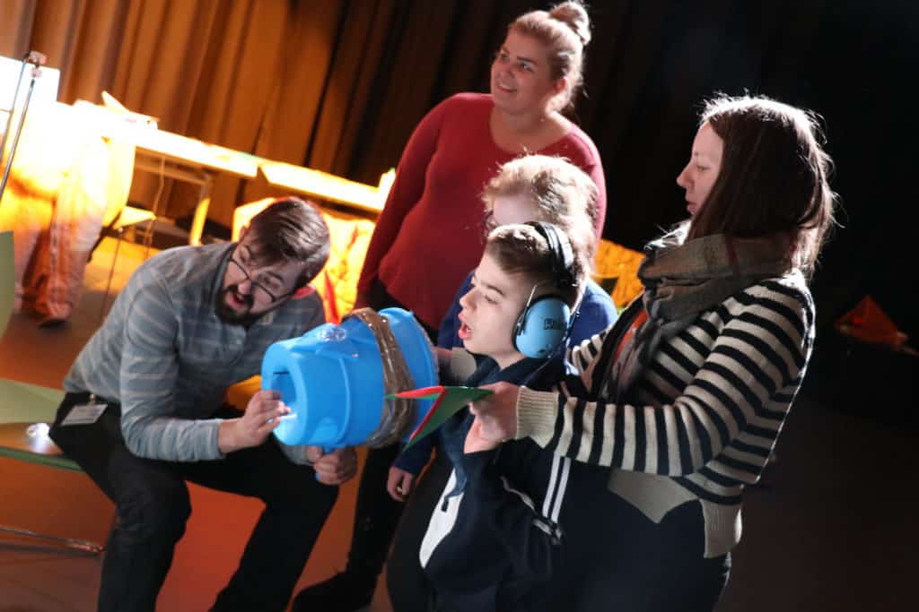 a group of people using a sonic tennis instrument