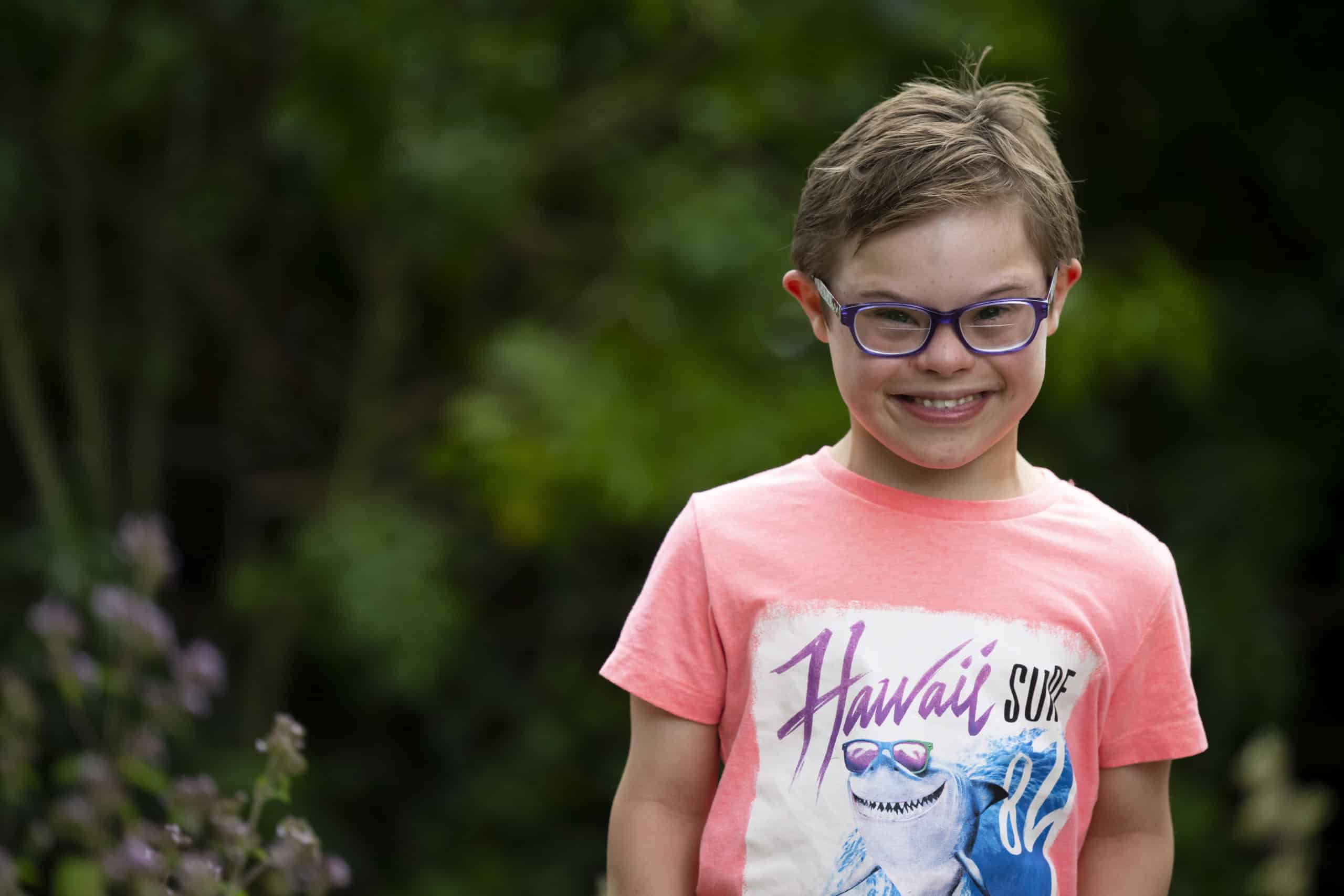 Ernie, a young boy with Down's syndrome, smiling at the camera.