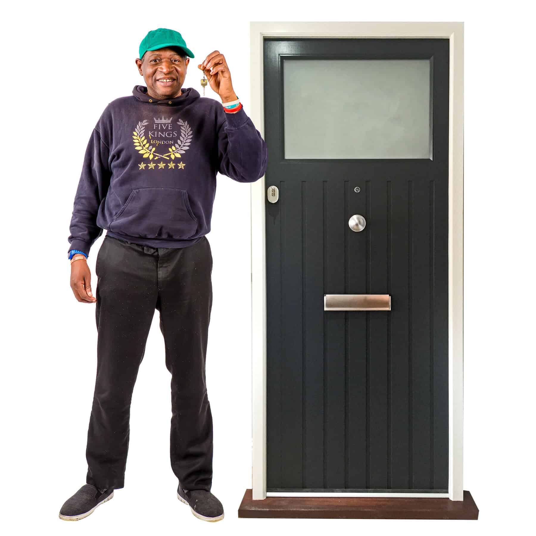 A man holds a key next to a door