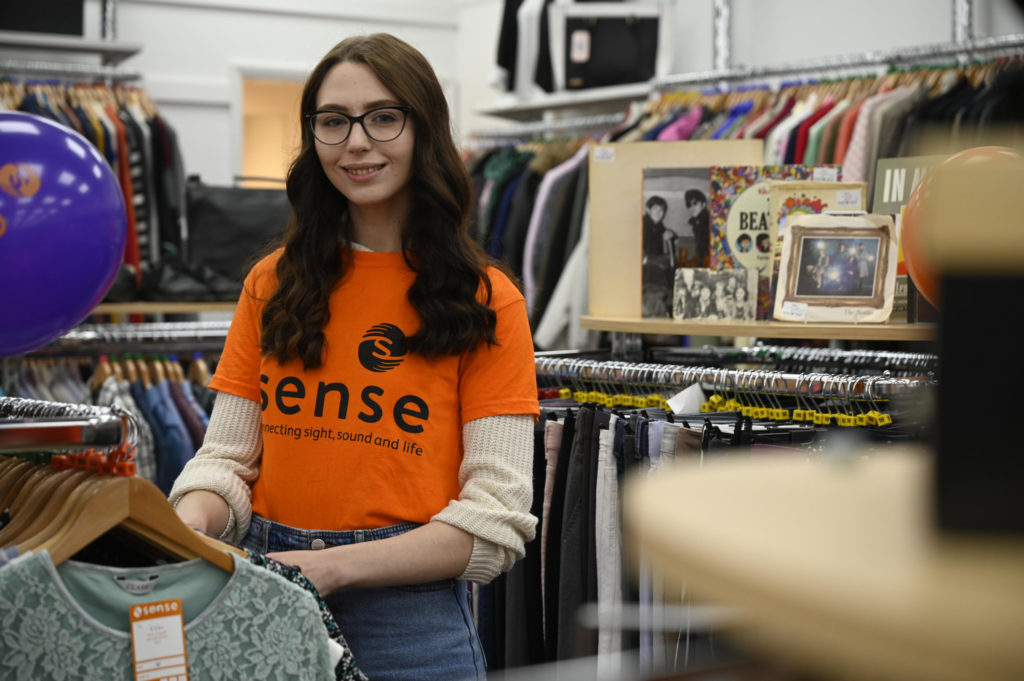Woman in Sense shop smiling at camera
