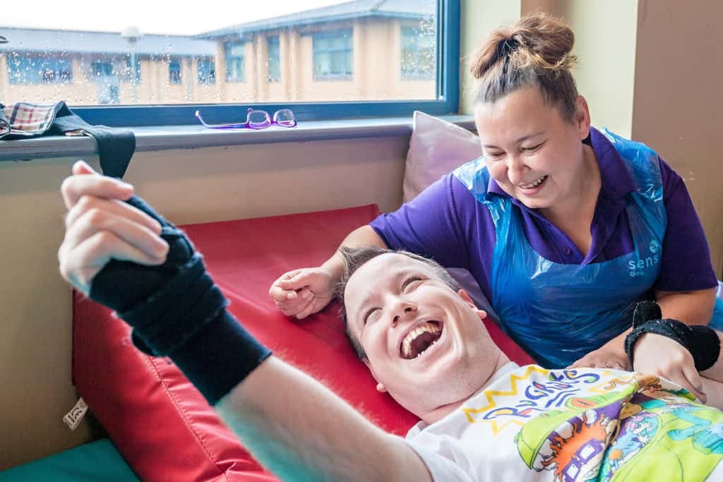 child and carer smiling and laughing