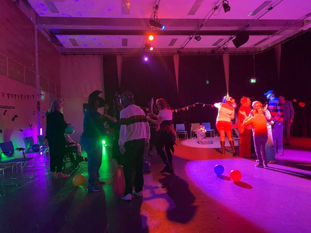 A group of people enjoying a Halloween party.